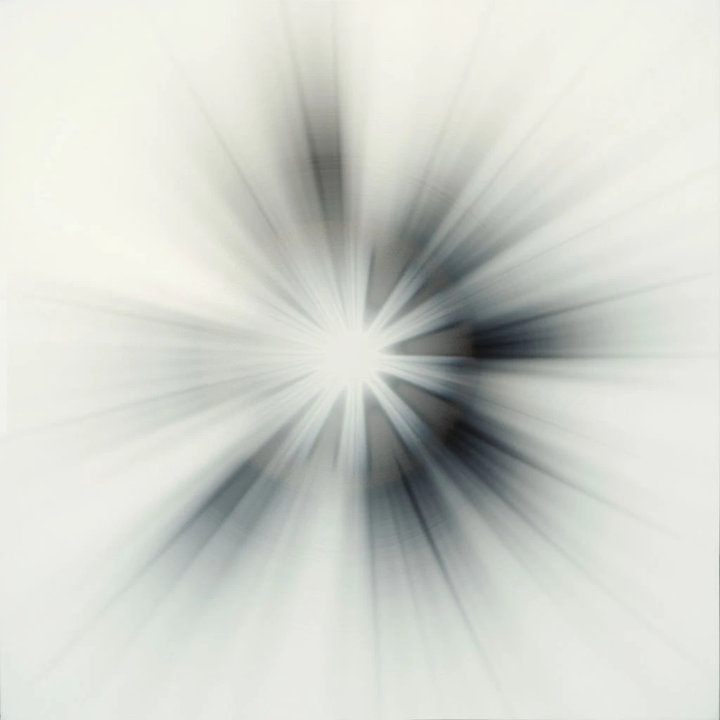 A bright, central burst of light radiates outwards with streaks of silver and gray. The image is heavily blurred, suggesting rapid movement or a strong force emanating from the center. Dark shapes are vaguely visible within the core of the light explosion.